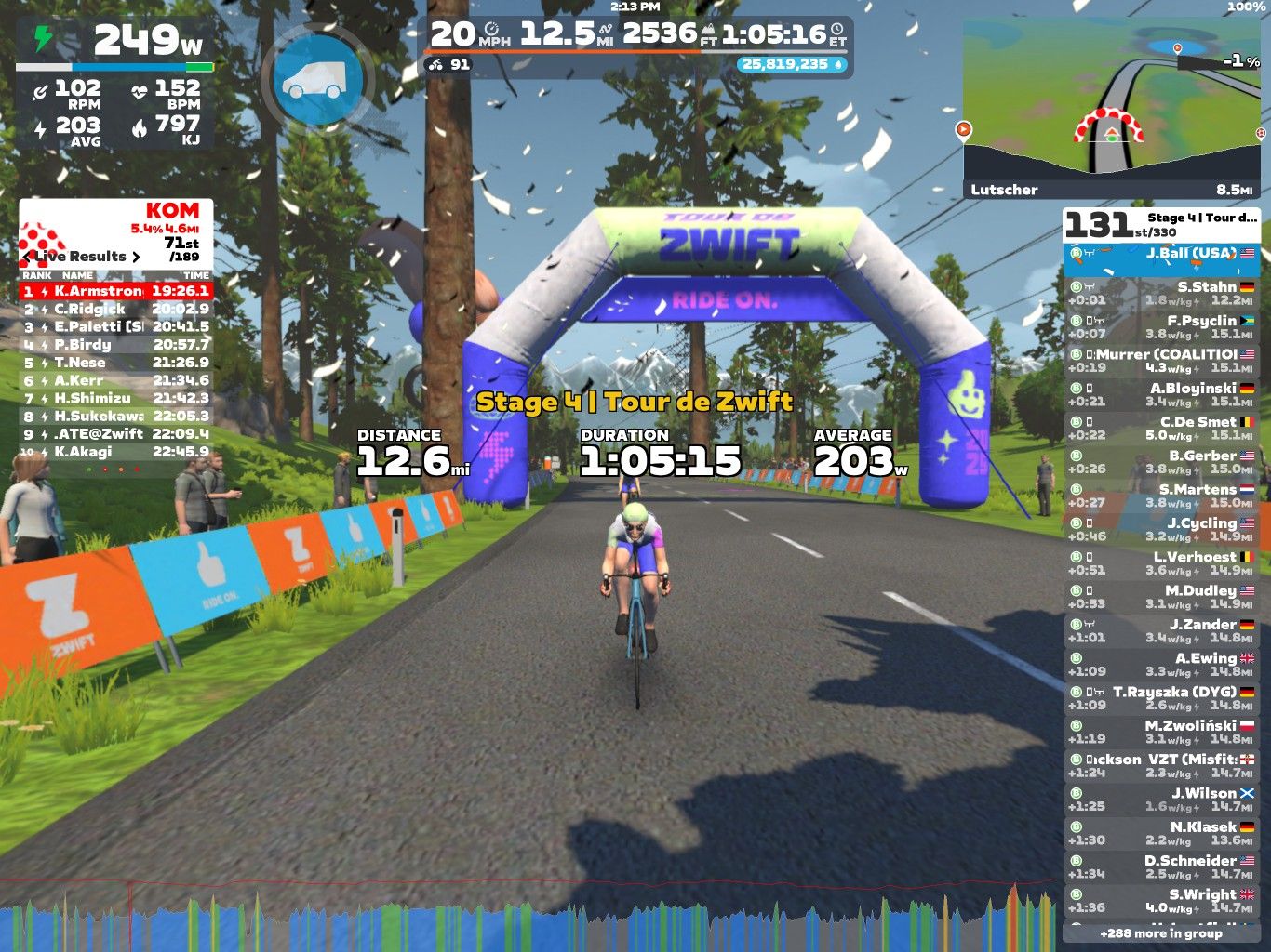 A cyclist rides towards the finish line marked by an inflatable arch with the text