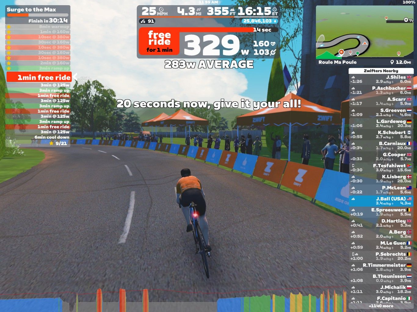 A cyclist is riding on a virtual course in Zwift, with statistics displayed on the left side, including speed and power output. The road curves ahead with trees and spectators visible. An event timer shows 
