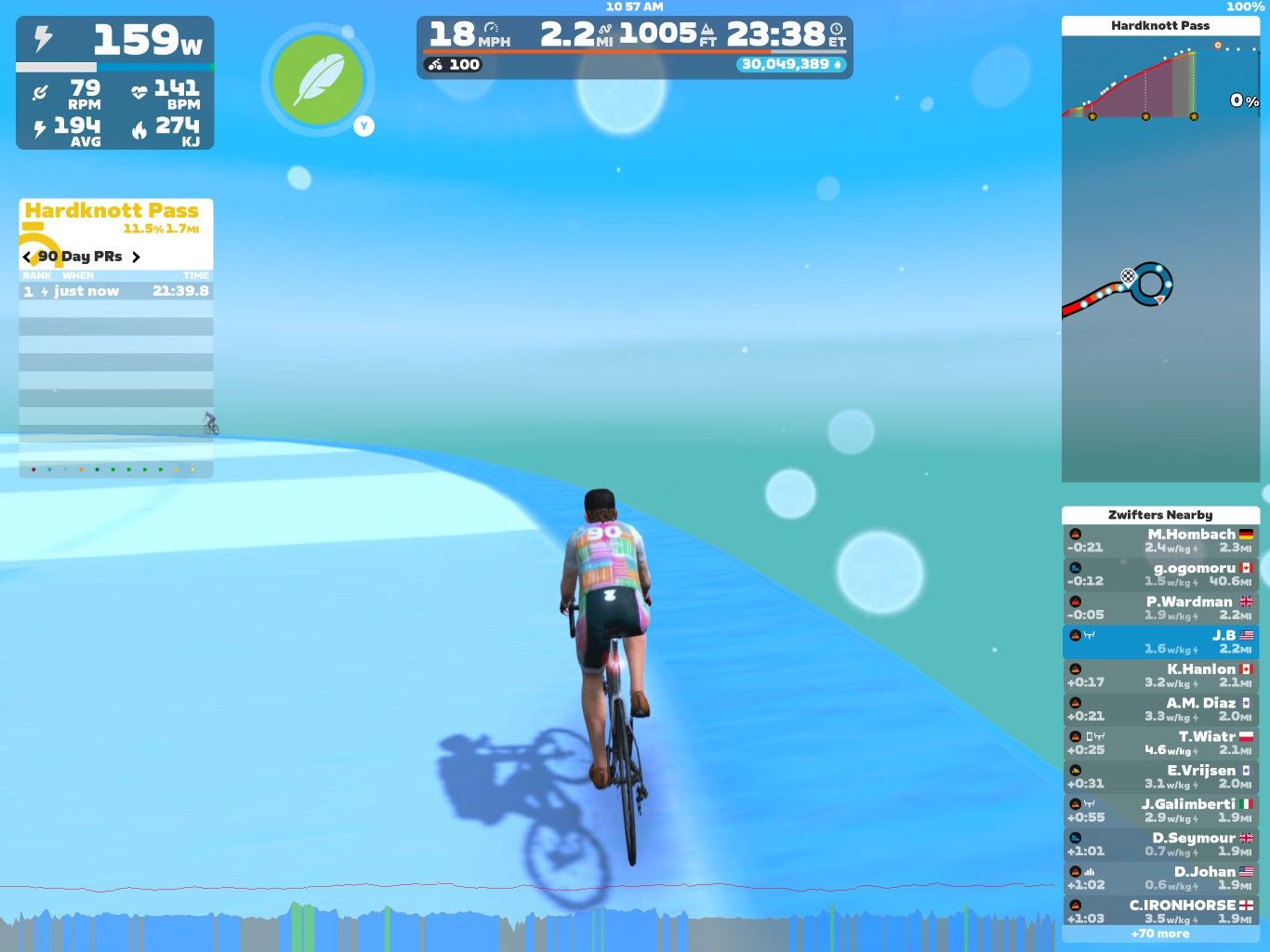 A cyclist rides on a virtual track in Zwift, labeled 